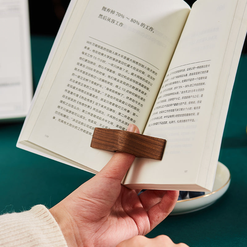 Book Pages Holding Finger Ring